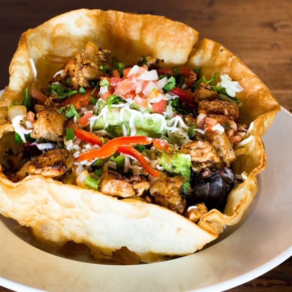 Favela's Mexican Grill taco salad with chicken, pico de gallo, guacamole, and sour cream in a crispy shell.